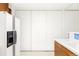 Bright kitchen area features white appliances, ample storage, and modern fixtures, perfect for cooking at 7170 W 8Th Pl, Lakewood, CO 80214