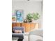 Cozy living area showcases a sideboard with art and decor, comfortable seating, and a bright, inviting atmosphere at 7170 W 8Th Pl, Lakewood, CO 80214