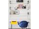 Office space with open shelves, modern lighting, and a bright chair at 7170 W 8Th Pl, Lakewood, CO 80214