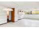 Bright room featuring shelving, cabinets, a window, and access to another room at 7170 W 8Th Pl, Lakewood, CO 80214