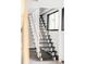 Staircase with modern design, black steps, and white railings at 7170 W 8Th Pl, Lakewood, CO 80214