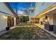 Charming backyard at dusk features a patio, outdoor kitchen, and treehouse at 11 S Albion St, Denver, CO 80246
