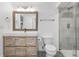 Modern bathroom with a rustic vanity, tiled floor, and glass shower at 11 S Albion St, Denver, CO 80246