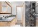 Bathroom featuring a vanity with granite countertops, a shower, and plenty of lighting at 11 S Albion St, Denver, CO 80246