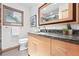 Bathroom featuring a window with coverings, vanity with granite countertops, and plenty of lighting at 11 S Albion St, Denver, CO 80246