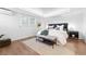 Bright bedroom with hardwood floors, a large bed, and modern lighting, creating a comfortable retreat at 11 S Albion St, Denver, CO 80246