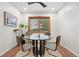 Cozy dining area with a glass-top table, metal chairs, and a decorative ceiling fan at 11 S Albion St, Denver, CO 80246