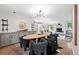 Open dining room featuring wood floors, modern lighting, a fireplace and an adjacent living room at 11 S Albion St, Denver, CO 80246