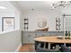 Dining room with stylish light fixture, hardwood floors, convenient bar area and dining table at 11 S Albion St, Denver, CO 80246