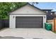 Two car garage with black paneled door is nestled in the backyard behind the home at 11 S Albion St, Denver, CO 80246