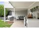 Outdoor kitchen boasts a built-in grill, bar seating, and adjacent patio with comfortable seating at 11 S Albion St, Denver, CO 80246