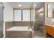 Modern bathroom featuring a soaking tub and a glass-enclosed shower with mosaic tile at 1401 Wewatta St # 709, Denver, CO 80202