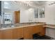 Bathroom vanity featuring double sinks, ample cabinet space, and modern fixtures at 1401 Wewatta St # 709, Denver, CO 80202