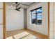 Bright bedroom with downtown views, hardwood floors, and a modern ceiling fan at 1401 Wewatta St # 709, Denver, CO 80202