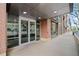 Modern apartment building entrance with glass doors, brick accents, and sidewalk access at 1401 Wewatta St # 709, Denver, CO 80202