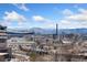 Panoramic city view showcasing the skyline, mountains, and a local amusement park at 1401 Wewatta St # 709, Denver, CO 80202