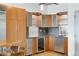 Modern kitchen with stainless steel appliances, granite countertops, wooden cabinets, and wine fridge at 1401 Wewatta St # 709, Denver, CO 80202