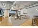 Modern living room with hardwood floors, industrial ceiling, city views, and neutral furniture at 1401 Wewatta St # 709, Denver, CO 80202