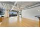 Contemporary living room with hardwood floors, industrial ceiling, city views, and exposed ductwork at 1401 Wewatta St # 709, Denver, CO 80202