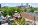 Scenic aerial view showcasing the home's proximity to downtown amidst lush greenery, featuring a city skyline backdrop at 1154 N Clarkson St, Denver, CO 80218