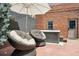 Cozy backyard with comfortable seating under a large umbrella and a hot tub at 1154 N Clarkson St, Denver, CO 80218