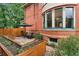Tranquil backyard with raised garden beds, a patio seating area, and a verdant lawn at 1154 N Clarkson St, Denver, CO 80218