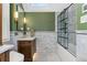 Bright bathroom with a marble surround shower and a classic vanity with gold fixtures at 1154 N Clarkson St, Denver, CO 80218