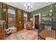 Cozy Bedroom featuring hardwood floors, multiple windows, and comfortable chair at 1154 N Clarkson St, Denver, CO 80218