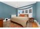 Comfortable bedroom with natural light from the bay window, hardwood floors and radiator at 1154 N Clarkson St, Denver, CO 80218