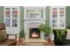 Close up of the fireplace with lit fire, flanked by built in shelving at 1154 N Clarkson St, Denver, CO 80218