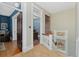Hallway featuring hardwood floors, stained glass, and doors leading to various rooms at 1154 N Clarkson St, Denver, CO 80218