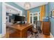 Bright home office featuring a large desk, bay window with yellow curtains, and stylish light fixture at 1154 N Clarkson St, Denver, CO 80218