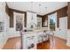 Bright kitchen featuring a center island, granite countertops, pendant lights, and modern appliances at 1154 N Clarkson St, Denver, CO 80218