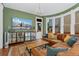 Inviting living room with a large TV, comfortable seating, and bay windows offering natural light at 1154 N Clarkson St, Denver, CO 80218