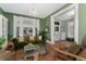 Elegant living room featuring a chandelier, large windows, and comfortable seating arrangements at 1154 N Clarkson St, Denver, CO 80218