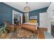 A well-lit main bedroom featuring hardwood floors, decorative rug, and a stylish light fixture at 1154 N Clarkson St, Denver, CO 80218