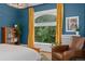 Well-lit main bedroom featuring a large arched window with stained glass, and hardwood floors at 1154 N Clarkson St, Denver, CO 80218