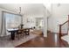 Open concept dining area with hardwood floors and modern chandelier at 12773 E 105 Th Pl, Commerce City, CO 80022