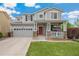 Two-story house with gray siding, red door, and a landscaped lawn at 12773 E 105 Th Pl, Commerce City, CO 80022