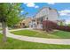 Two-story house with gray siding, red door, and a landscaped lawn at 12773 E 105 Th Pl, Commerce City, CO 80022