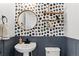 Stylish powder room, featuring a pedestal sink and modern wallpaper at 12773 E 105 Th Pl, Commerce City, CO 80022