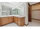 Bright bathroom featuring double sinks and a walk-in closet at 13457 Glen Cir, Broomfield, CO 80020