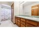 Traditional bathroom with double sinks and wood cabinets at 13457 Glen Cir, Broomfield, CO 80020