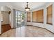 Bright dining area with sliding glass door to deck, tile floor and warm wood window trim at 13457 Glen Cir, Broomfield, CO 80020