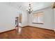Spacious dining room featuring hardwood floors, classic chandelier, and bright windows at 13457 Glen Cir, Broomfield, CO 80020
