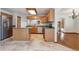 Kitchen featuring stainless steel appliances, tile floors, and an island for extra counter space at 13457 Glen Cir, Broomfield, CO 80020