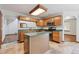 Open kitchen featuring stainless steel appliances, tile floors, and an island for extra counter space at 13457 Glen Cir, Broomfield, CO 80020