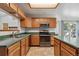 Bright kitchen features stainless steel appliances, tile floors, island, and sliding glass door to deck at 13457 Glen Cir, Broomfield, CO 80020