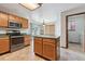 Open kitchen with tile floors, an island, stainless steel appliances, and access to the laundry room at 13457 Glen Cir, Broomfield, CO 80020