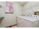 Laundry room featuring washer, dryer, shelf, and window at 13457 Glen Cir, Broomfield, CO 80020